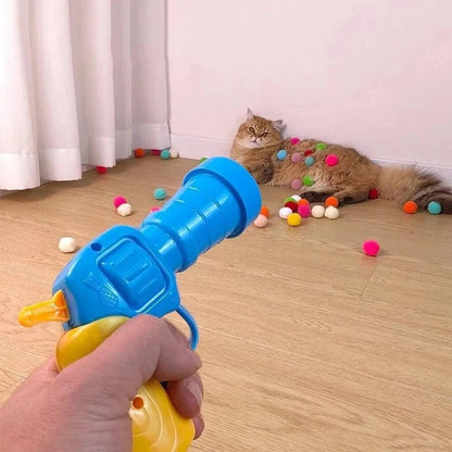 A hand holding a launcher, ready to toss balls during playtime.