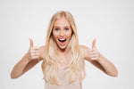 Woman with blonde hair giving a thumbs-up gesture on a white background