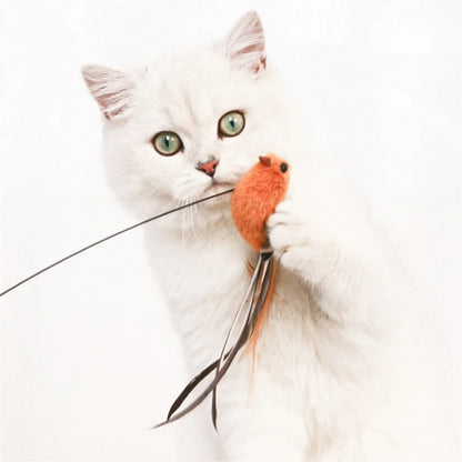 A white cat playing with a bird-shaped toy attached to a wire